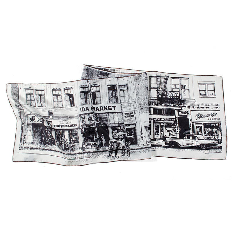 Folded pearl gray silk scarf with vintage image of First St. printed in black.